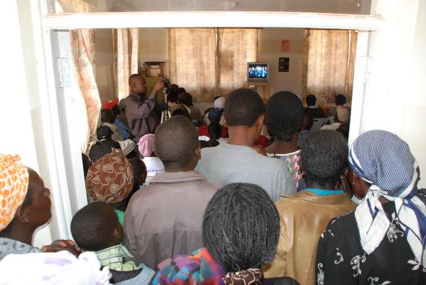 People crowd in to watch 'An African Answer' in Burnt Forest