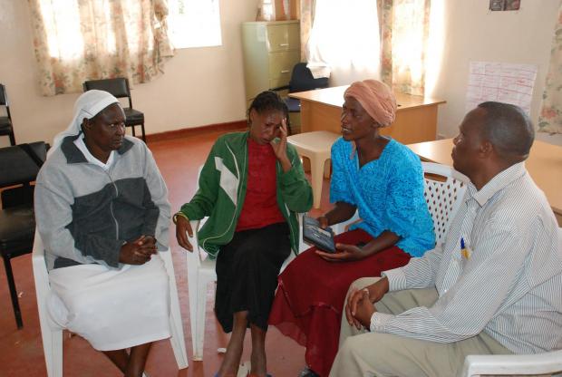 Sister Macrina Cheruto from the International Organization for Migration and Joseph Wainaina from Initiatives of Change offer counsel to Leah Muthoni (second left), a victim of the post-election violence, and Cecilia Kimemia, after the film screening.