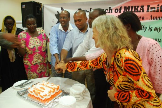 Ceremonial cutting and sharing of a large chocolate cake at the end of the occasion.