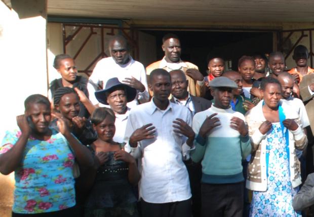 Participants at the retreat demonstrate a trauma tapping exercise