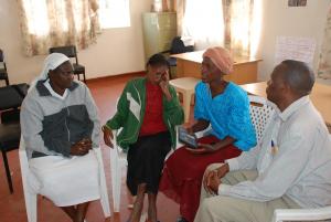 Sister Macrina Cheruto from the International Organization for Migration and Joseph Wainaina from Initiatives of Change offer counsel to Leah Muthoni (second left), a victim of the post-election violence, and Cecilia Kimemia, after the film screening. (Photo: Alan Channer)