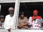 Workshop participant Aysha Dafalla reads a Peace Declaration from an open-air truck at the scene of the bomb blast in Eastleigh.  Also present, from left to right, Pastor James Wuye, Imam Muhammad Ashafa, District Commissioner Omar Beja and District Commisioner George Natembeya.