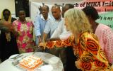 Ceremonial cutting and sharing of a large chocolate cake at the end of the occasion.