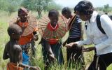 Pokot women show grass seed to Ilchamus community leader Maryann Lekisemon (right).